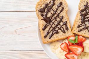 whole wheat bread with fresh banana, strawberry and chocolate