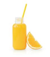 Orange juice in bottle with drinking straw and slice of orange photo