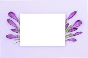 Holiday background with isolated white middle part surrounded by purple backdrop and a bouquet of flowers on the sides