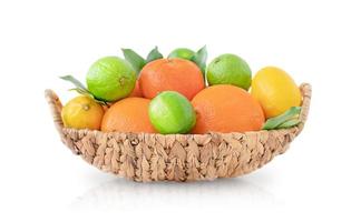 Wicker basket with citrus fruit isolated on white surface photo