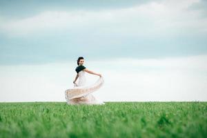 bride with a bouquet in an ivory dress and a knitted shawl photo