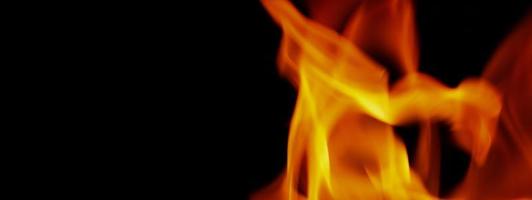 Fire background. Abstract burning flame and black background. photo