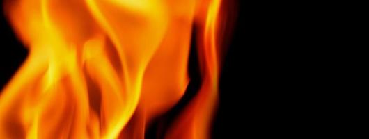 Fire background. Abstract burning flame and black background. photo