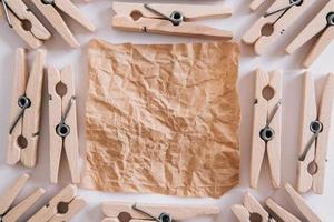 Woodenl clothespins, paper clip and brown sticker on white background. Isolated on white. View from above. Place for your text photo