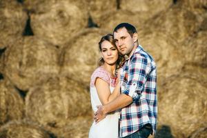 a guy with a girl on a summer walk in the field photo