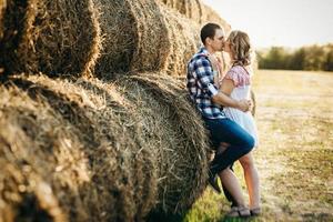 a guy with a girl on a summer walk in the field photo