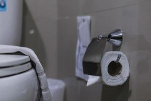 Clean toilet paper in the bathroom. Being folded and being used for the hotel guests photo