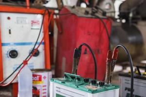 In the repair shop, a battery charger is in use. photo