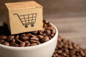 Box with shopping cart logo symbol on coffee beans, Import Export Shopping online or eCommerce delivery service store product shipping, trade, supplier concept. photo