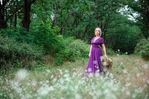 Girl model blonde in a lilac dress with a bouquet photo