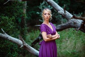 Girl model blonde in a lilac dress with a bouquet photo