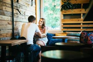 guy and a girl meeting in a city cafe photo