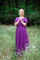 Girl model blonde in a lilac dress with a bouquet photo