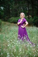 Girl model blonde in a lilac dress with a bouquet photo