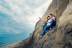 guy and a girl in jeans and white t-shirts on the beach photo