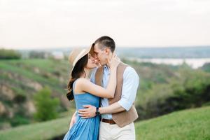 young couple a guy and a girl are walking in the mountain hills photo