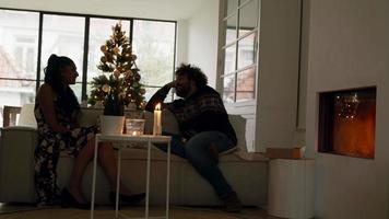 Woman and man talking on couch at Christmas
