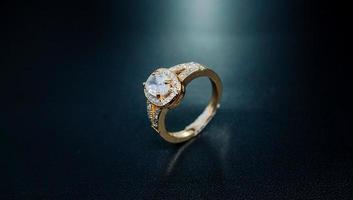 Photo of womens gold ring decorated with a sparkling diamond