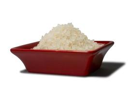 Rice in a red rectangular saucer isolated on white background. Close-up photo