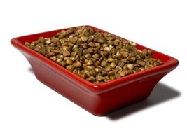 Buckwheat in a red rectangular saucer isolated on white background. Close-up photo