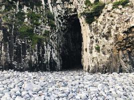 Rock cave entrance from a beach. Jeju island, South Korea photo