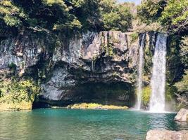 The high waterfall and the mountain lake in Jeju island. South Korea photo