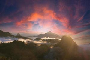 Beautiful mountain sunrise with sunlight and fog over northern Thailand's mountains photo