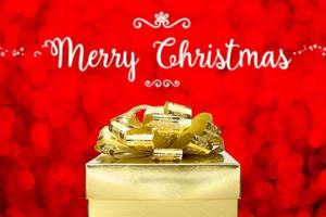 Merry Christmas with Golden Present box at red bokeh light background photo