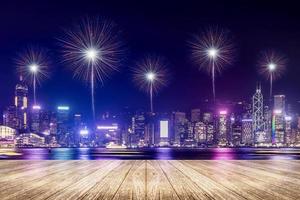 Empty wood plank floor with fireworks over cityscape at night background