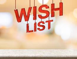 Wish list word hanging over marble table with blurred bokeh photo