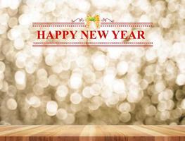 Happy New Year word in perspective room with golden sparkling bokeh lights and wooden  floor photo