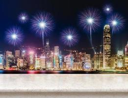 Empty white glossy marble table top with fireworks over cityscape at night background