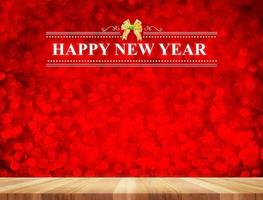 Happy New Year word in perspective room with red sparkling bokeh lights and wooden floor, photo