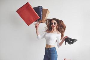 Finally upgraded my locker stuff. Just from the shopping. Stylish young woman holding the packages with clothes and heels photo