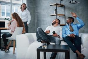 Beautiful place or working. Group of multiracial office workers in formal clothes talking about tasks and plans photo