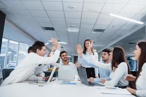 Group of office workers happy to hit their own records and being successful photo
