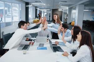 Cheerful business people. Job is done. Group of office workers happy to hit their own records and being successful photo