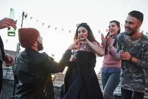 She said yes. Declaration of love on the rooftop with company of friends photo