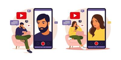 Woman and man video bloggers sitting on sofa with phone and recording video with smartphone. Different social media icons. Vector illustration in flat style.