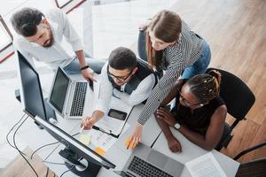 A group of multinational busy people working in the office. photo