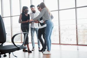 Young business people are discussing new creative ideas together during a meeting in the office photo