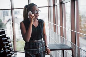 An American business woman speaks on her cellphone in the office. photo