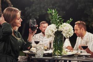 Girl adores flowers. Friends have meeting at evening. Nice outside restaurant photo