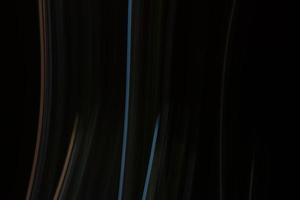 Abstract dark background with vertical multicolored lines. photo