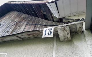 An old abandoned house at number 13 with a broken roof. photo