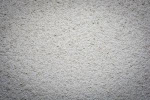 Concrete wall background covered with white rough cement mortar. photo