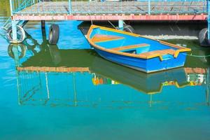 Blue one boat near the metal pier. photo