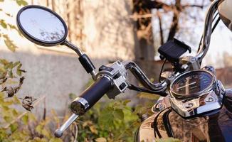 handlebar and speedometer of classic chopper motorcycle close up photo