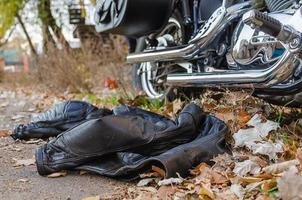 leather jacket of biker and classic motorcycle chopper photo