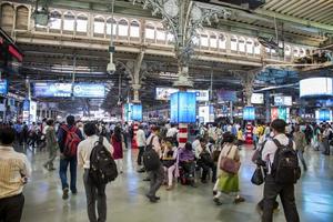 MUMBAI, INDIA, OCTOBER 9,  2015 -  Unidentified people at platform of Chhatrapati Shivaji Terminus railway station in Mumbai. It is a UNESCO World Heritage Site and an historic railway station photo